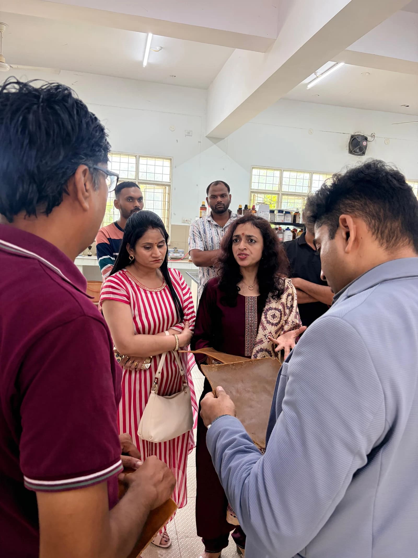 The visiting committee in discussion during the laboratory visit.