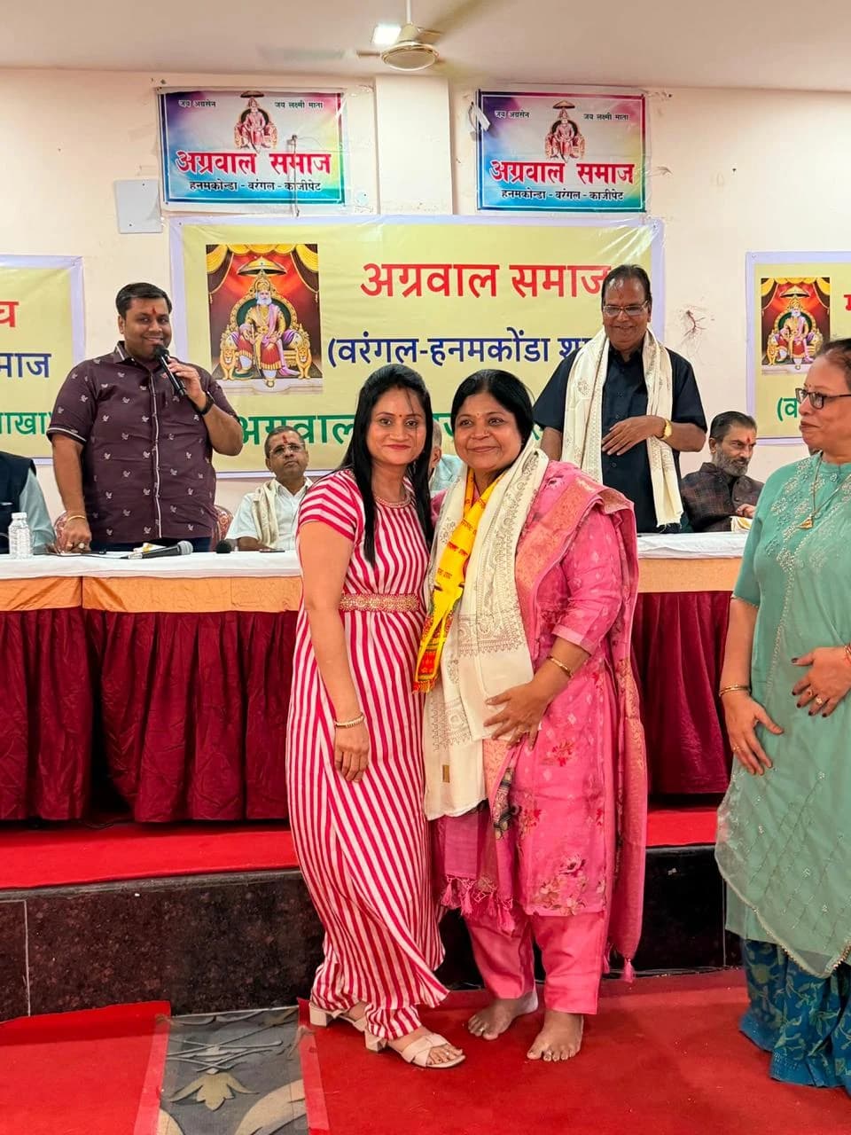 A photograph together with a ceremonial shawl and yellow stole.