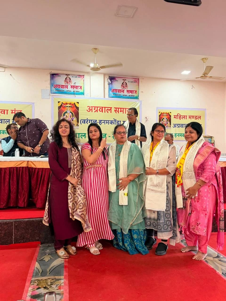 Five participants gather for a photograph at the opening.